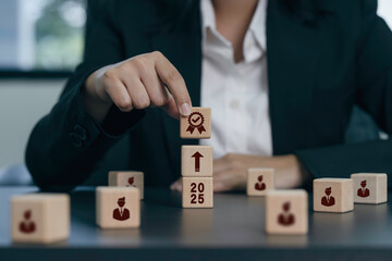 Businesswoman holding wooden blocks with award icon on wood cube block in hand holding, Victory,...