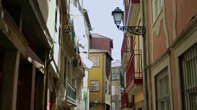 A handheld, stabilized shot of the buildings by the streets in Porto, Portugal.