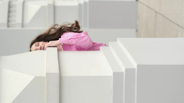The girl mischievously peeks from behind the corner of a building, as if playing hide and seek with the camera. Energy and spontaneity create an atmosphere of fun and joy.
