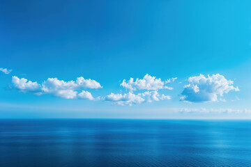 Obraz premium White clouds with deep blue sky over a calm ocean