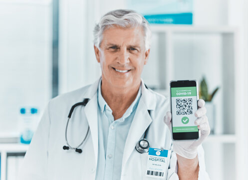 Doctor, portrait and phone with QR code for covid 19, info and vaccine status in hospital. Healthcare, mature man and screen of mobile with barcode, scan or contactless payment option in consultation