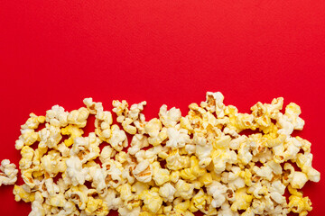 Salty popcorn on bright color background. Cinema and entertainment concept. Movie night with popcorn. Delicious appetizer, snack.Space for text, copy space. Banner