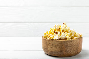 Salty popcorn on bright color background. Cinema and entertainment concept. Movie night with popcorn. Delicious appetizer, snack.Space for text, copy space. Banner