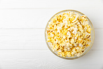 Salty popcorn on bright color background. Cinema and entertainment concept. Movie night with popcorn. Delicious appetizer, snack.Space for text, copy space. Banner