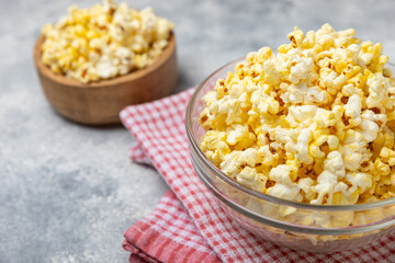 Salty popcorn on bright color background. Cinema and entertainment concept. Movie night with popcorn. Delicious appetizer, snack.Space for text, copy space. Banner
