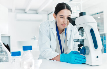 Microscope, woman and scientist checking for science breakthrough, clinical trial and discovery....