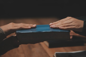 Christian group are praying to god with the bible and sharing the gospel. Concept of faith for god.