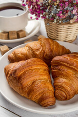 Tea with croissants on a light table. Sweet breakfast