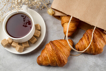 Tea with croissants on a light table. Sweet breakfast