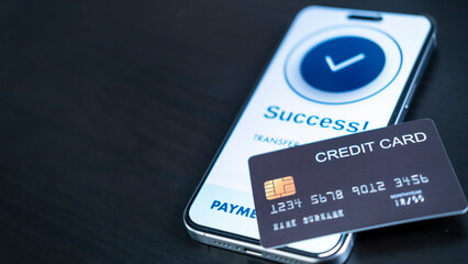 smartphone screen shows a successful payment confirmation, with a credit card. The image emphasizes...