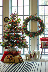decorated Christmas tree in red with presents under the tree in the living room
