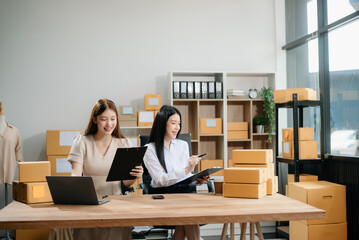 Starting small businesses SME owners, two check online orders Selling products working