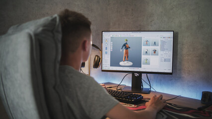 Young designer creates and draws clothes using PC. Interface of professional 3D modeling or design software. Teenage boy working on freelance project on computer at home. Game development concept.
