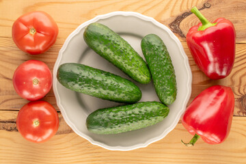 Fresh ripe vegetables on wooden table, macro, top view.