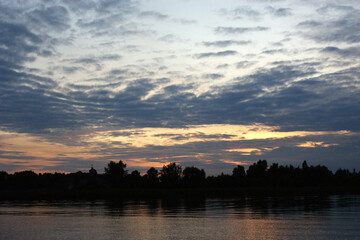 Niegocin lake Mazury Poland sunset on the lake with orange sky cloudy clouds red and purple sun