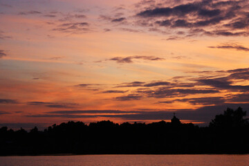 Niegocin lake Mazury Poland sunset on the lake with orange sky cloudy clouds red and purple sun