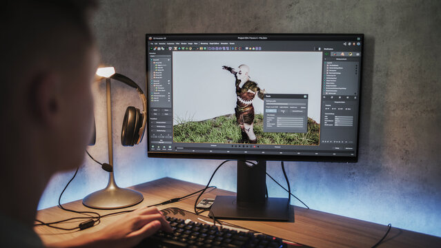 Young designer creates 3D model and animation of game character using computer. Interface of professional 3D modeling software. Teen boy working on freelance project on PC at home. Game development.