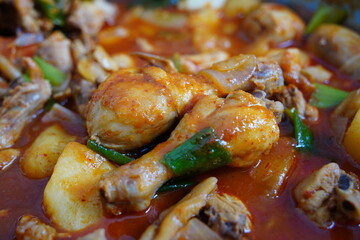 Spicy Braised Chicken dish is made by boiling chicken, potatoes, and onions in a sauce
