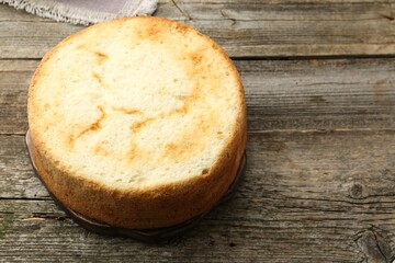 Tasty sponge cake on wooden table, space for text