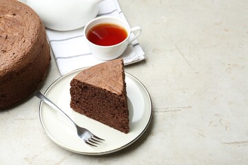 Piece of tasty chocolate sponge cake served on light table. Space for text