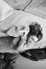 dreamy middle-aged woman on bed