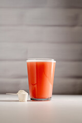 Collagen protein powder. Protein pink powder in a glass. 