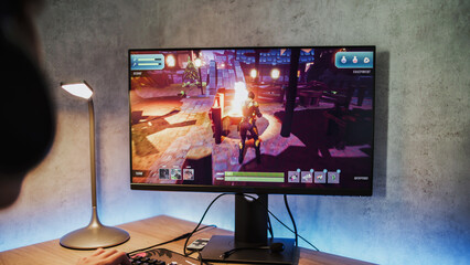 Professional young gamer wearing headphones plays online video game on computer. Caucasian teen boy spends leisure time at home, enjoys gameplay in 3D third person shooter on PC. Gaming and eSports. © Framestock