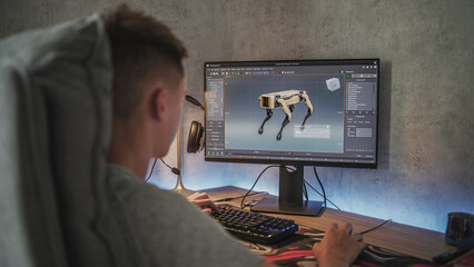 Young designer creates 3D model and animation of the robot dog using PC. Interface of professional 3D modeling software. Teenage boy working remotely on freelance project on computer at home.