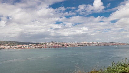 Panorama showing Lisbon cityscape and Tagus river timelapse with 25 of April bridge