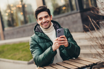 Obraz premium Photo of positive good mood man sitting relaxing enjoying weekend in cafe terrace autumn weather day outdoors