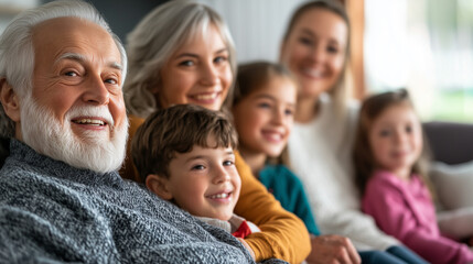 Obraz premium Extended family of six sitting on a couch, smiling and happy, grandparents and children sharing a joyful moment, warm and welcoming living room, copy space