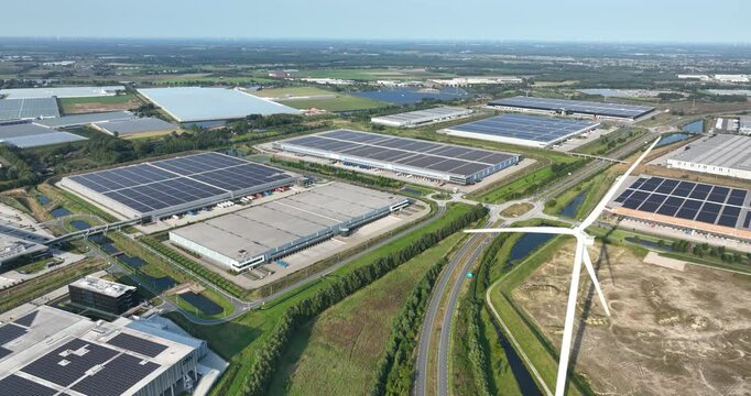 Business park in Venlo, modern distribution centers solars panels on the roof. Aerial drone video