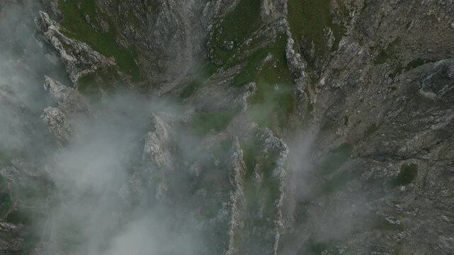 Lombardy, Italy - The Craggy, Rocky Peaks Covered in Fog Atop Grignetta - Aerial Topdown Shot
