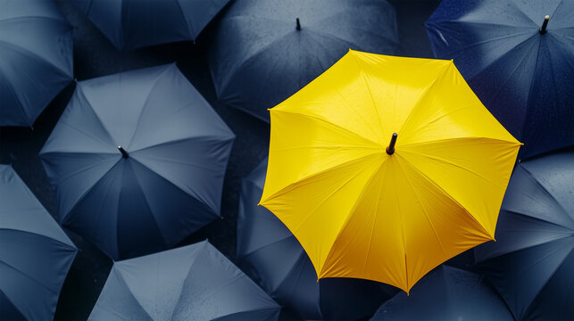 Top View of an Open Yellow Umbrella Standing Out Among Black Umbrellas, Concept of Individuality, Protection and Optimism.