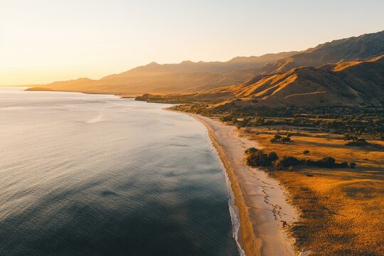 A tranquil beach at dawn with pastel-colored skies and gentle waves. Beautiful simple AI generated image