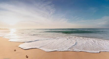 beach in the morning with gentle waves reaching the shore.