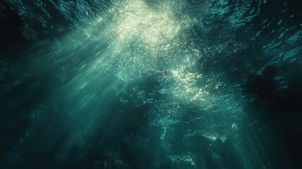 Fototapeta premium Beneath the ocean surface, light streams through the water creating a serene and mystical underwater view.