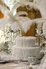 white table decorated with down, pearls, ribbons, prepared for a wedding ceremony, New Year's table