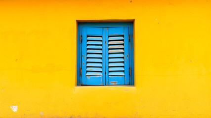Blue window on yellow wall 