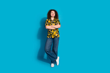 Full length photo of cheerful pretty lady dressed print shirt arms folded empty space isolated blue color background