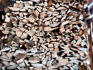 chopped stock of firewood for the winter stacked on top of each other, authentic texture