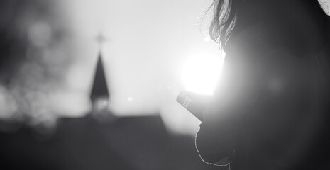Christian going to church holding bible on Sunday with bright sun light background, faith and...
