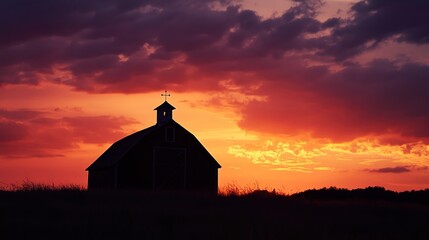 Fototapeta premium Silhouetted Barn at Sunset
