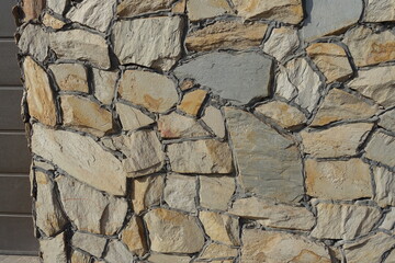 wall made of beige natural shape field stones