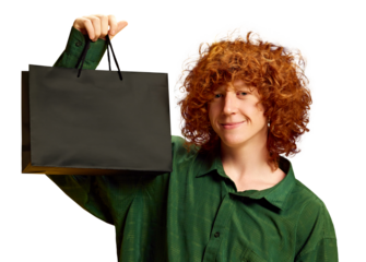 Stylish young man holding black bag with empty space to insert your text or logo against transparent background. Concept of Black Friday, Cyber Monday, fashion, Flash Sale. Ad