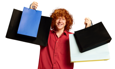 Young man happy after day of shopping posing with colorful packages with gifts, purchases against transparent background. Concept of Black Friday, Cyber Monday, fashion, Flash Sale. Ad