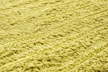 Yellow soft carpet textile texture with visible lines. The carpet is soft and fluffy, providing a cozy and comfortable feel