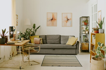 Cozy living room with different types of houseplants in pots, room made in earth colors