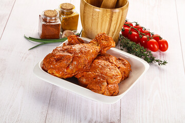 Raw turkey shoulder wing in Indian tandoori marinade