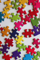 Colorful jigsaw puzzle pieces on white background. Flat lay.